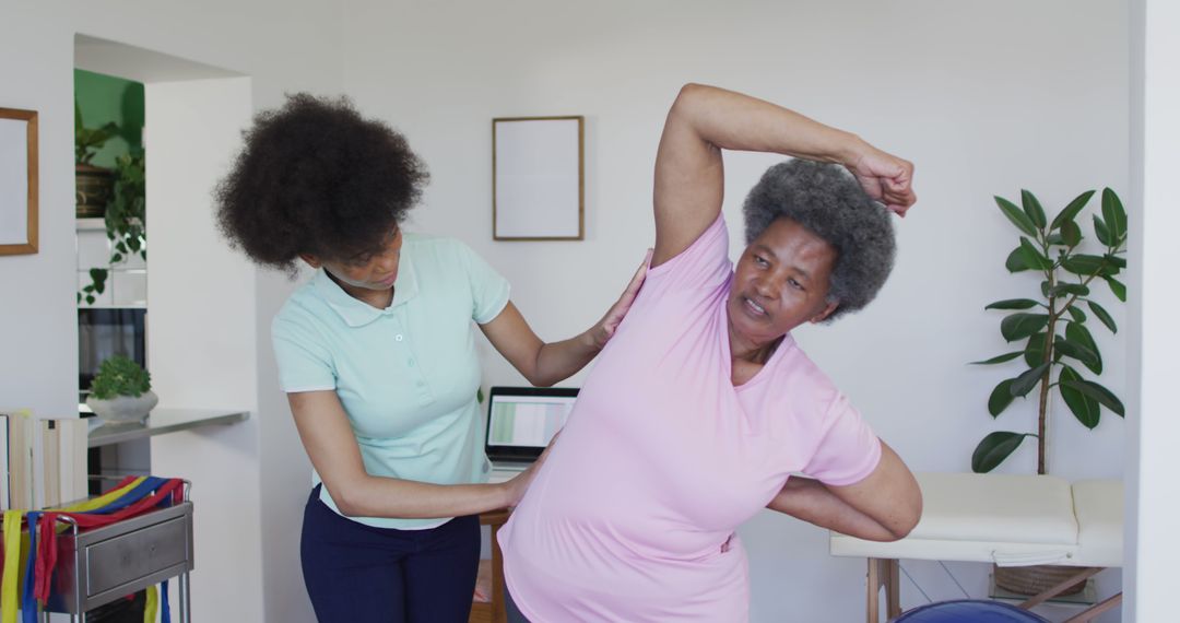 Physical Therapist Helping Elderly Woman With Stretching Exercise At Home - Free Images, Stock Photos and Pictures on Pikwizard.com