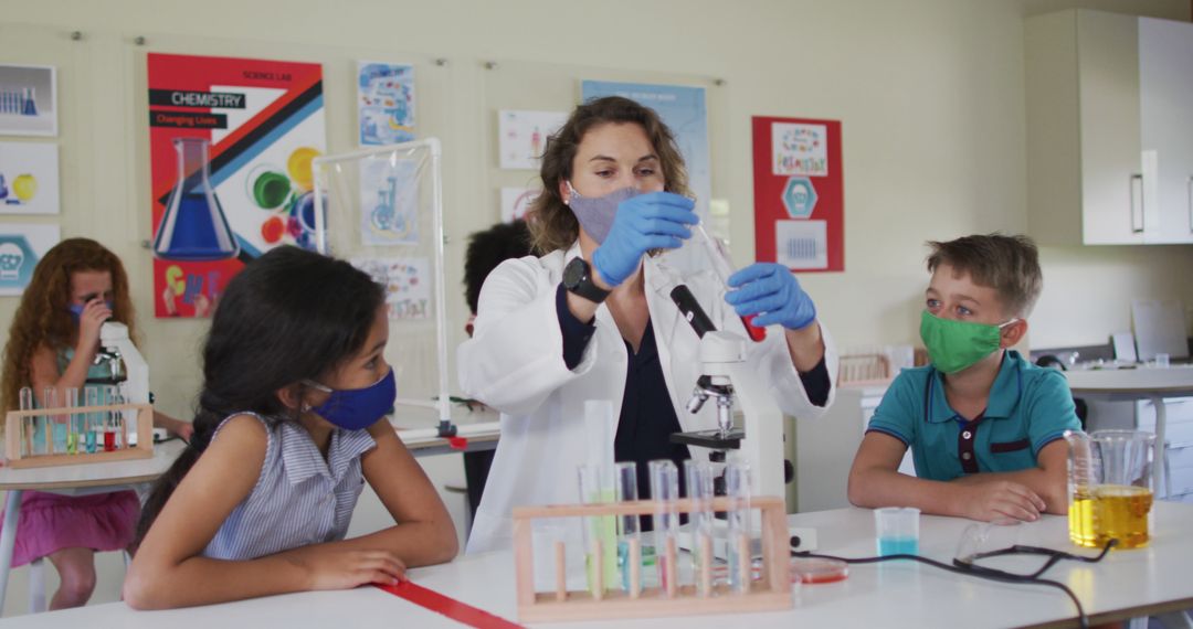 Female Teacher Conducting Science Experiment with Elementary Students in Classroom - Free Images, Stock Photos and Pictures on Pikwizard.com