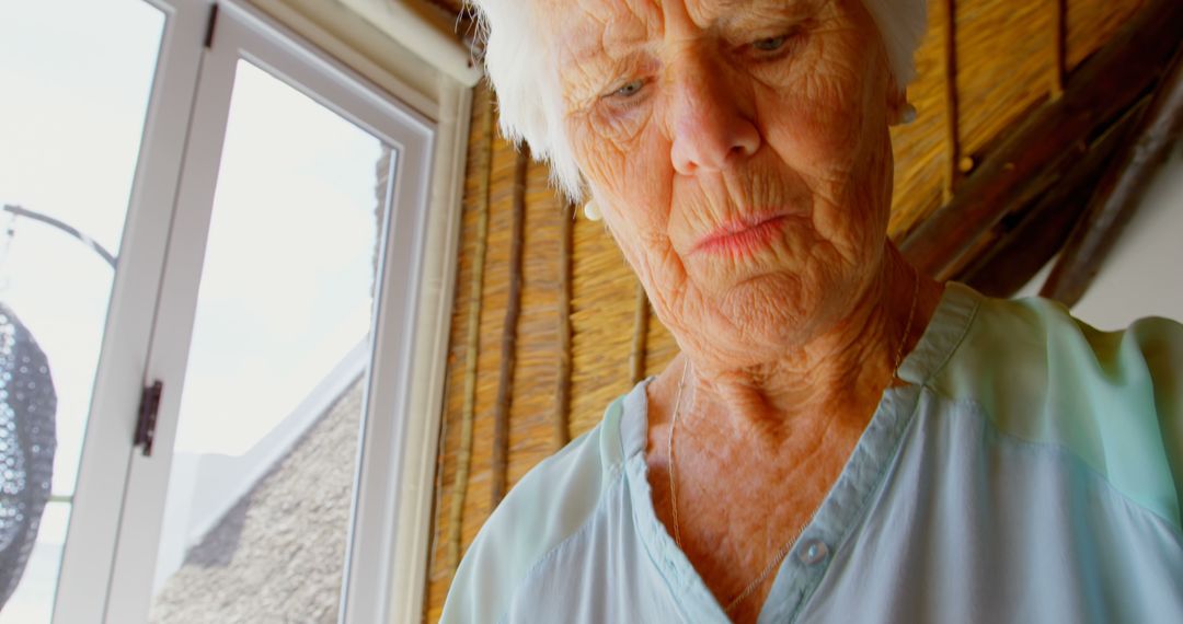 Senior Woman Reflecting Sunlight Indoors - Free Images, Stock Photos and Pictures on Pikwizard.com