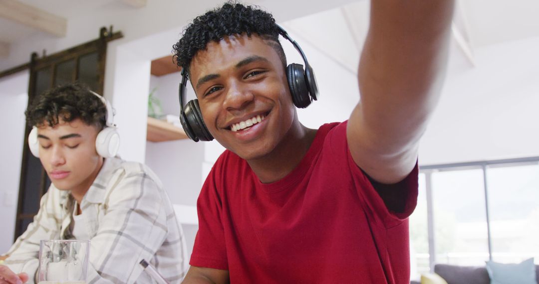 Smiling Teen Boy Wearing Headphones Taking Selfie at Home - Free Images, Stock Photos and Pictures on Pikwizard.com