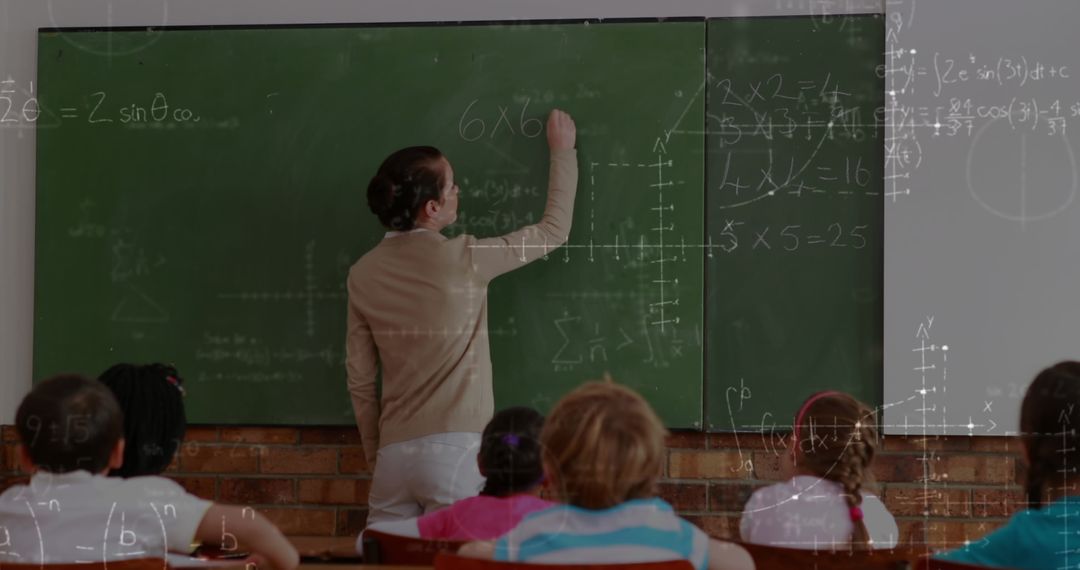 Math Teacher Writing Formulas on Classroom Chalkboard