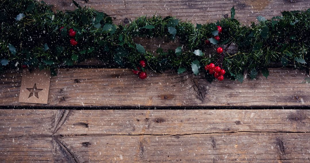 Festive Christmas Garland on Rustic Wooden Boards with Falling Snow