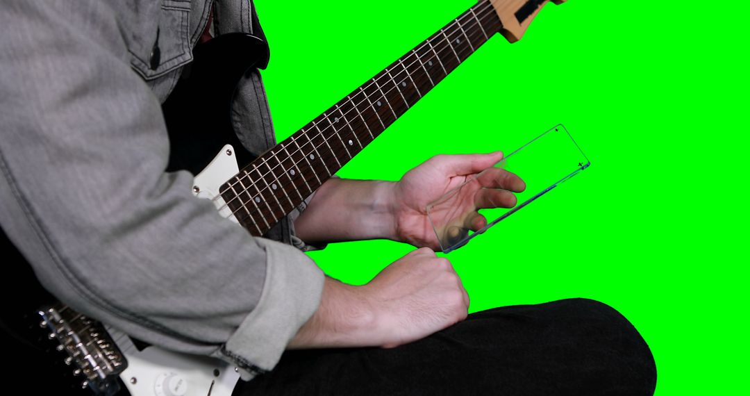 Guitarist Using Smartphone with Chroma Key Background - Free Images, Stock Photos and Pictures on Pikwizard.com