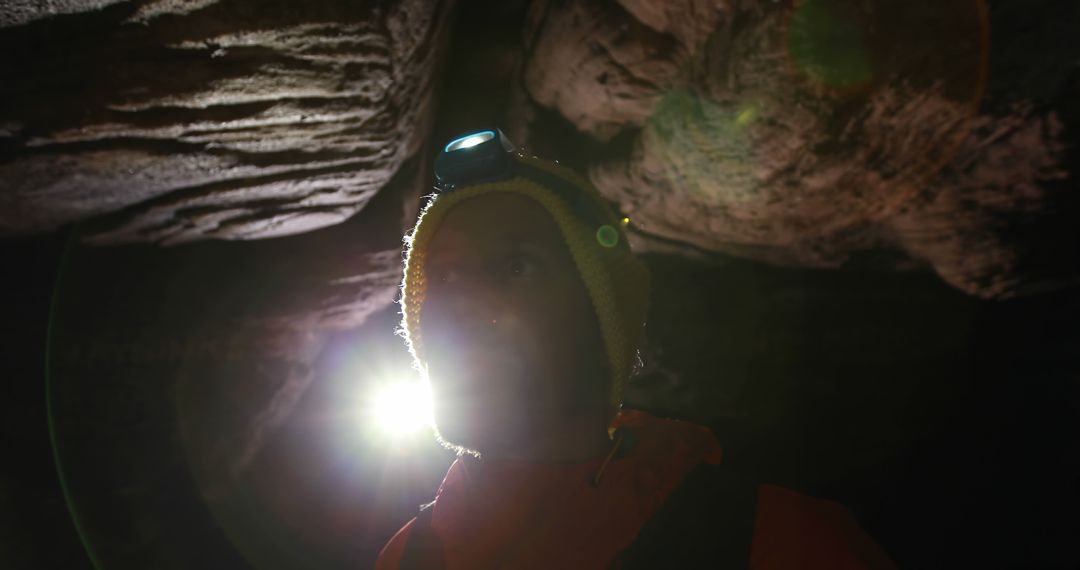 Cave Explorer Illuminated by Headlamp in Dark Cavern - Free Images, Stock Photos and Pictures on Pikwizard.com