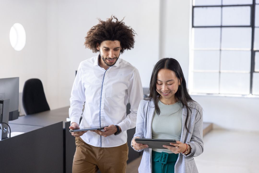Diverse Coworkers Walking and Collaborating in Modern Office
