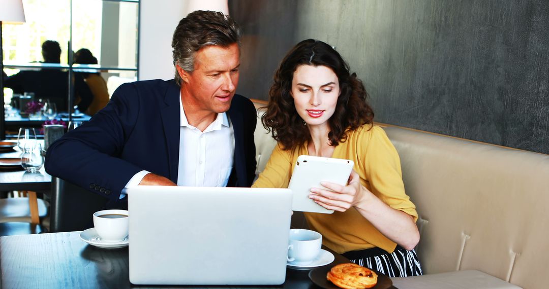 Professionals Collaborating in Modern Cafe Setting