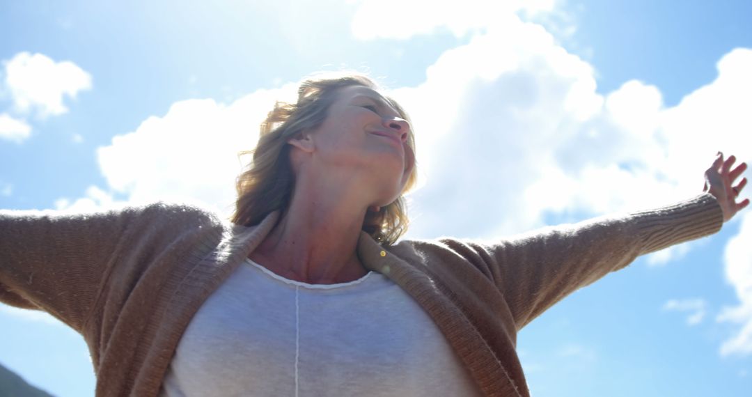 Woman Enjoying Freedom Outdoors Under Blue Sky - Free Images, Stock Photos and Pictures on Pikwizard.com