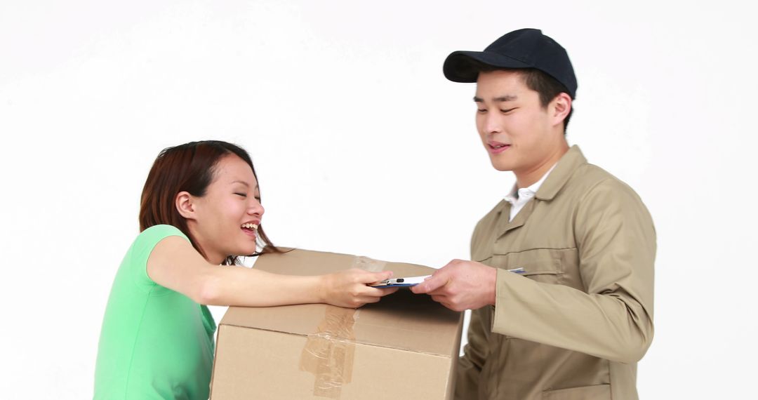 A delivery man hands a package to a woman, epitomizing modern e-commerce logistics. - Free Images, Stock Photos and Pictures on Pikwizard.com