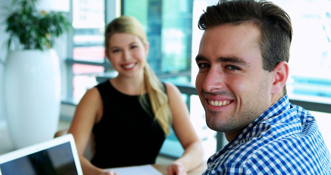 Smiling Business Professionals Collaborating in Bright Office