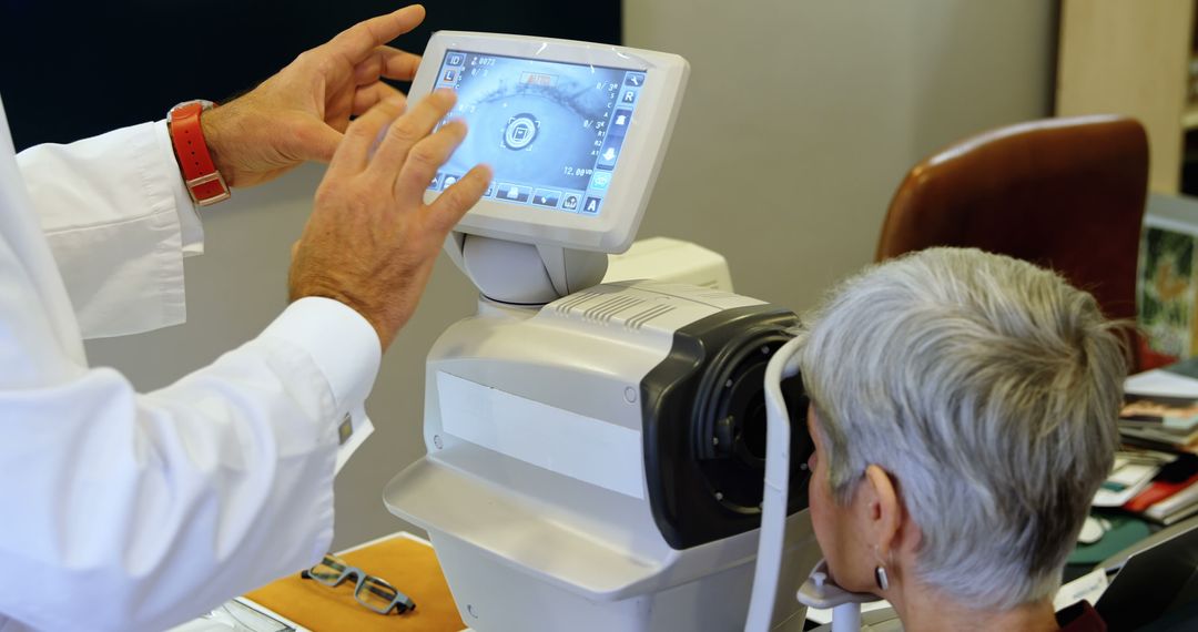 Doctor Adjusting Equipment While Senior Patient Undergoes Eye Examination - Free Images, Stock Photos and Pictures on Pikwizard.com