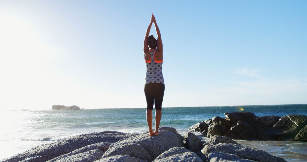 Woman Practicing Yoga on Rocky Beach During Sunrise - Free Images, Stock Photos and Pictures on Pikwizard.com