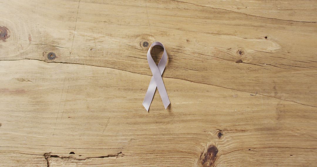 Lavender Ribbon Symbol on Wooden Surface Background - Free Images, Stock Photos and Pictures on Pikwizard.com