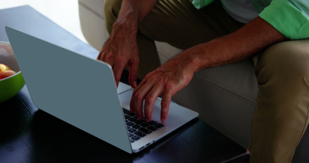 Man Working on Laptop in Modern Living room - Free Images, Stock Photos and Pictures on Pikwizard.com