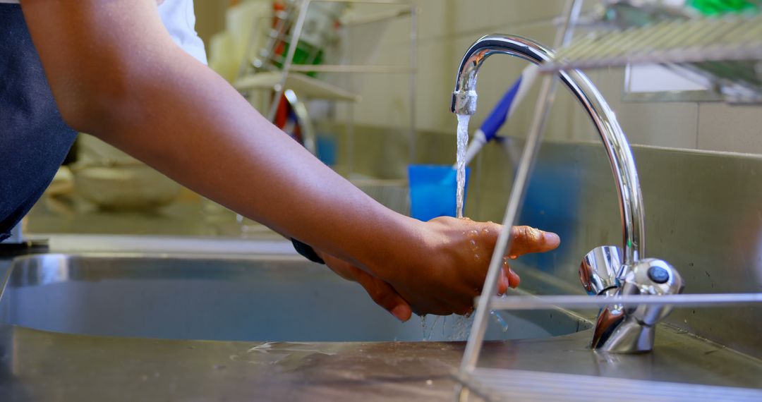 Close-up of person washing hands at kitchen sink for hygiene - Free Images, Stock Photos and Pictures on Pikwizard.com