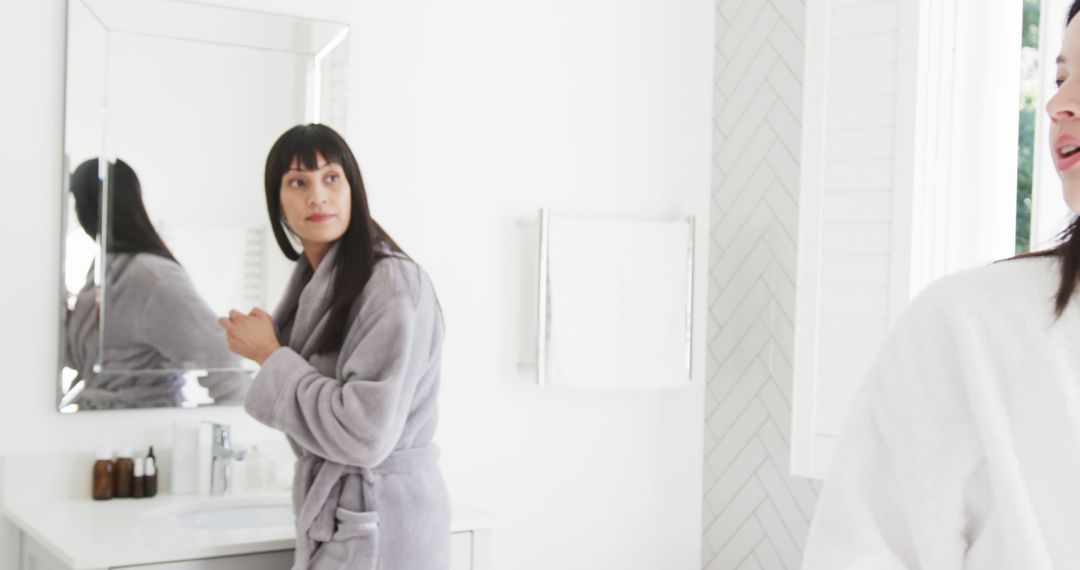 Woman in Bathroom Doing Morning Routine in Front of Mirror - Free Images, Stock Photos and Pictures on Pikwizard.com