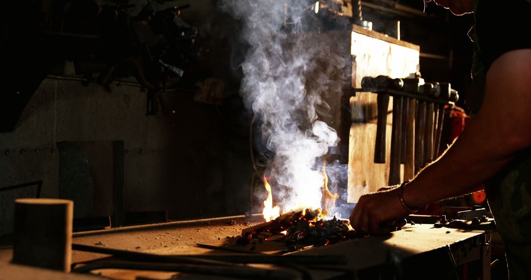 Blacksmith Working at Forge with Fire and Smoke - Free Images, Stock Photos and Pictures on Pikwizard.com