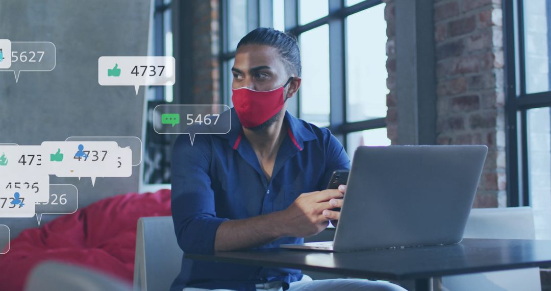 Businessman in Mask Monitoring Social Media in Urban Loft