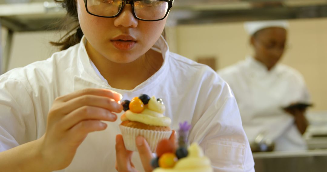 Pastry Chef Decorating Cupcake with Fresh Fruit - Free Images, Stock Photos and Pictures on Pikwizard.com