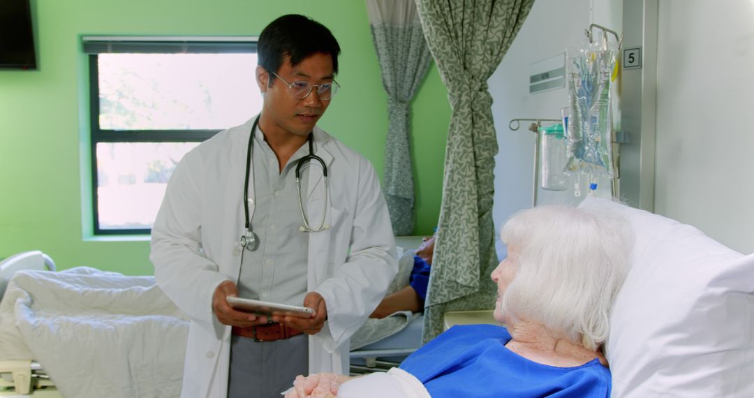 Doctor Caring for Elderly Patient in Hospital Room - Free Images, Stock Photos and Pictures on Pikwizard.com