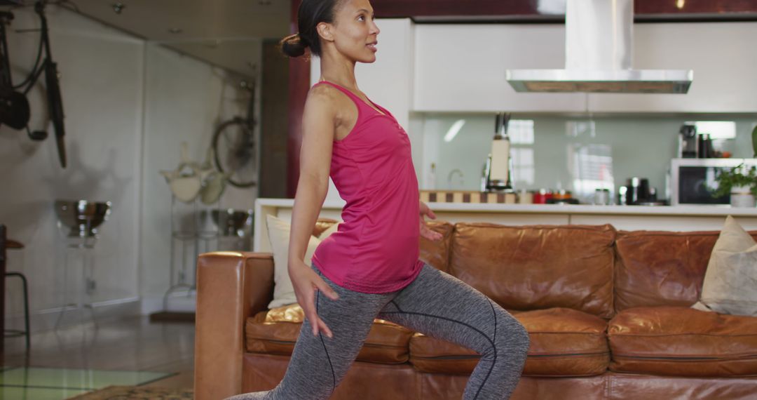 Biracial woman practicing yoga, stretching in living room - Free Images, Stock Photos and Pictures on Pikwizard.com