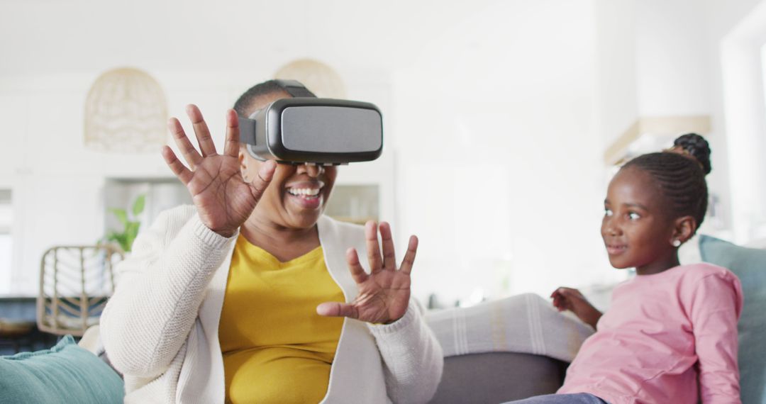 Grandmother Experiencing VR Technology with Curious Young Girl - Free Images, Stock Photos and Pictures on Pikwizard.com