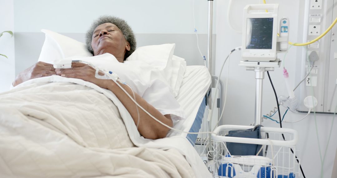 Elderly Patient Recovering in Hospital Bed with Medical Equipment - Free Images, Stock Photos and Pictures on Pikwizard.com