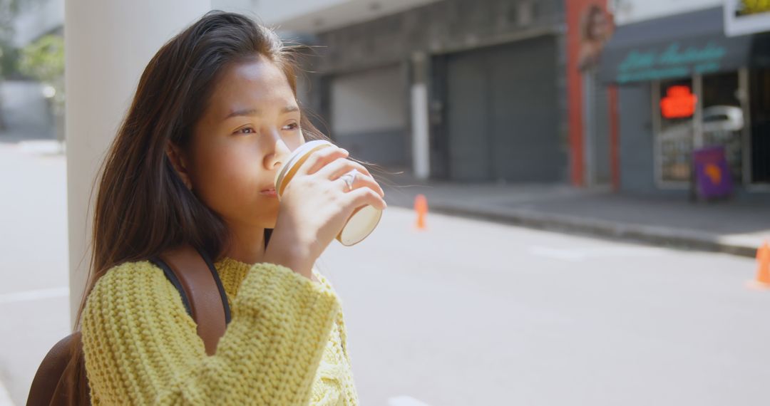 Pensive Young Woman Drinking Takeaway Coffee on Street - Free Images, Stock Photos and Pictures on Pikwizard.com