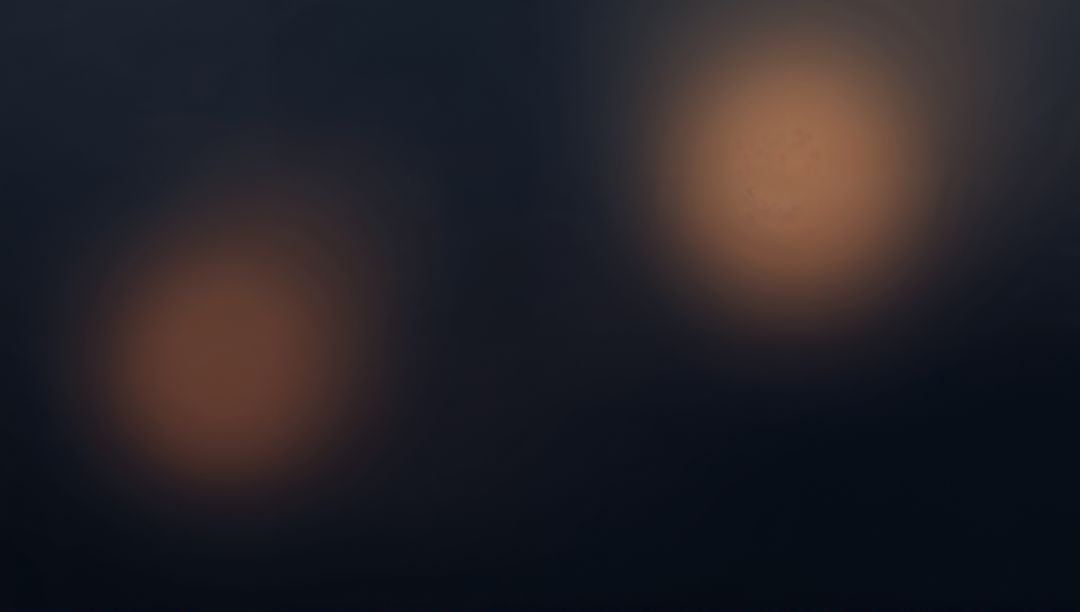 Warm Amber Bokeh Orbs Over Blue-Gray Gradient with Film Grain and Nocturnal Ambient Glow