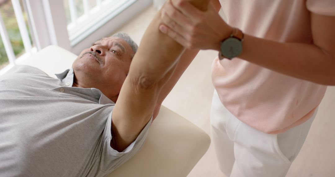 Senior Man Receiving Physical Therapy for Arm Pain Rehabilitation - Free Images, Stock Photos and Pictures on Pikwizard.com