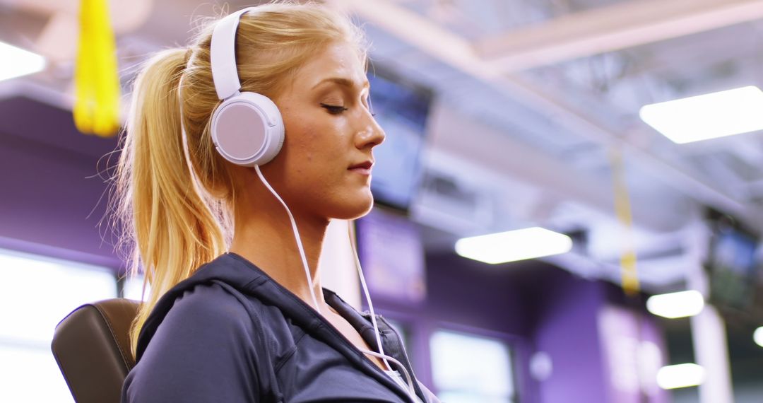 Woman Listening to Music with Headphones at Gym - Free Images, Stock Photos and Pictures on Pikwizard.com