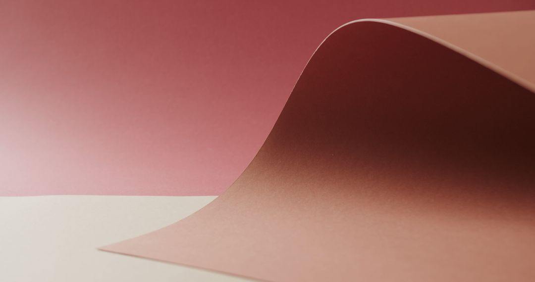 Minimalist Composition with Curved Red and Beige Paper