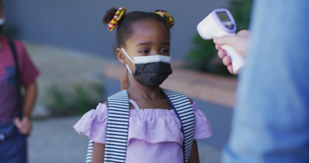 Schoolgirl Getting Temperature Checked During Pandemic - Free Images, Stock Photos and Pictures on Pikwizard.com