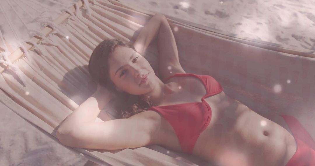 Serene Woman Relaxing in Hammock on Sunlit Beach