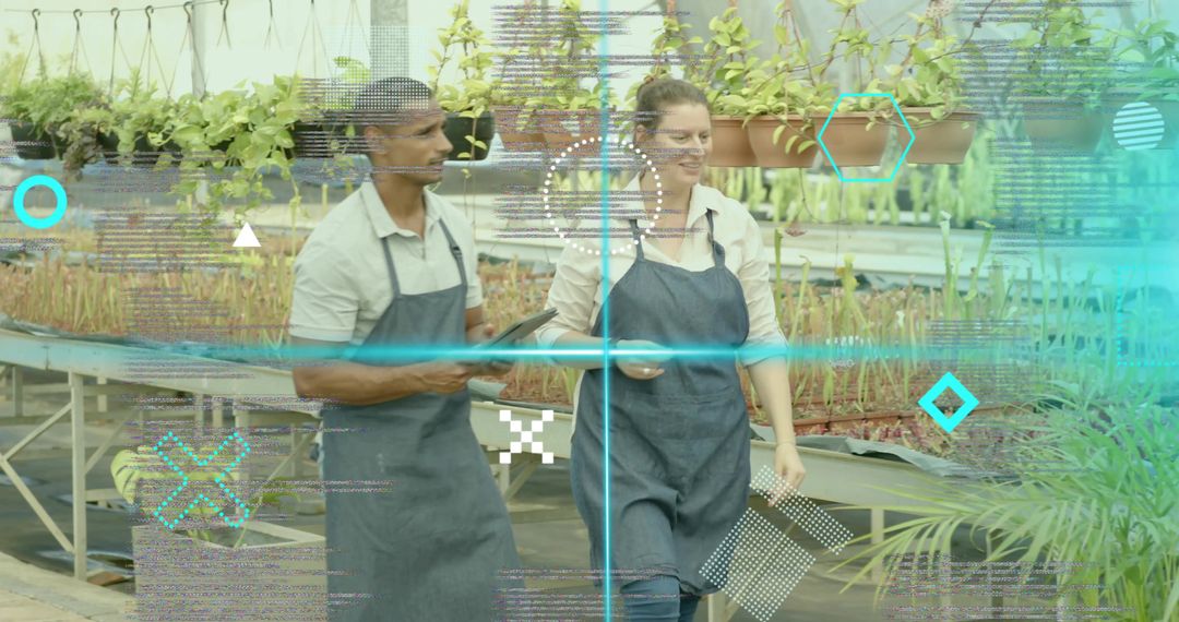 Greenhouse workers inspecting seedlings with tablet and smartphone for nursery automation