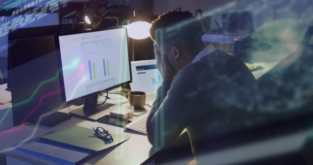 Businessman Frustrated by Data Analytics on Workplace Monitors