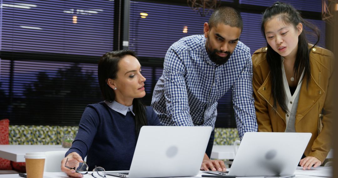 Diverse Team Collaborating on Technology Project in Office