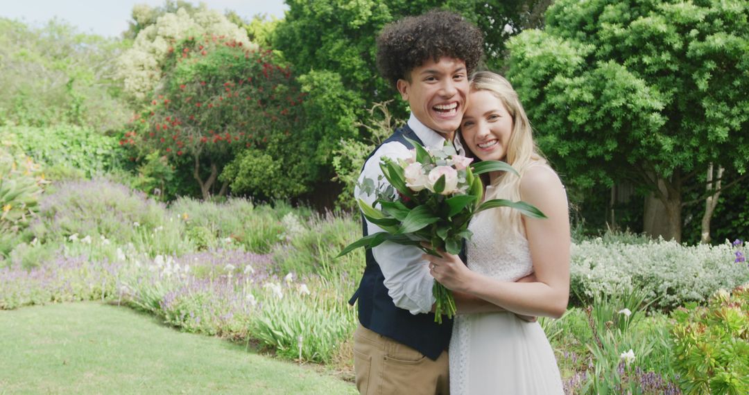 Joyful Multicultural Newlywed Couple Embracing in Vibrant Garden