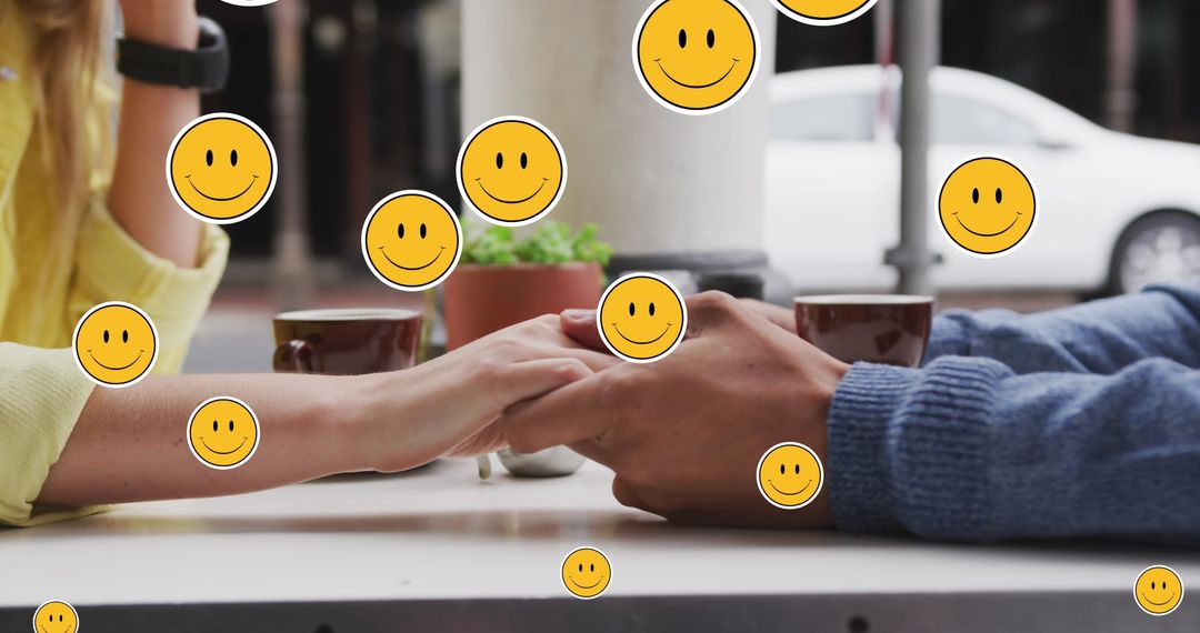 Couple Holding Hands with Emoji Overlay in Café Atmosphere