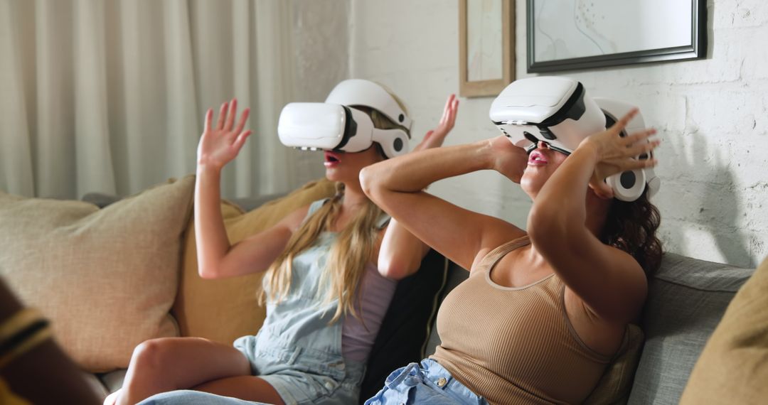 Young Women Immersed in Virtual Reality Adventure at Home