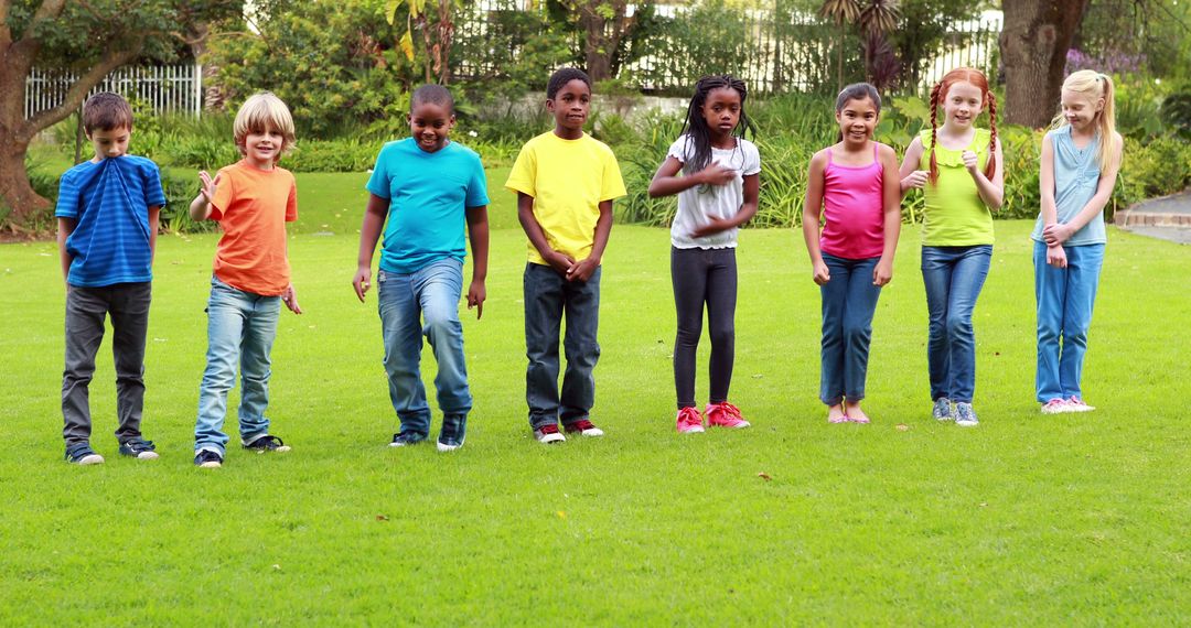 Kids of diverse backgrounds standing in line on grass - Free Images, Stock Photos and Pictures on Pikwizard.com