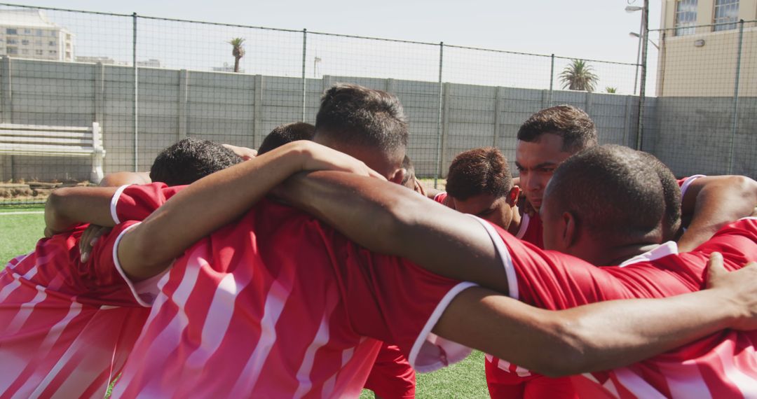 Male Soccer Team in Red Jerseys Huddling - Free Images, Stock Photos and Pictures on Pikwizard.com