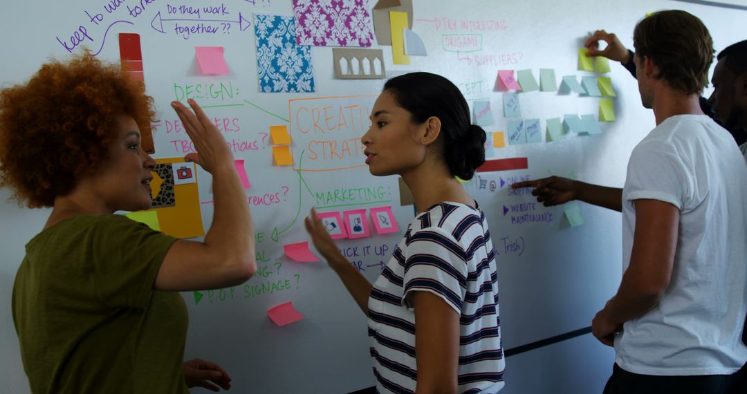Diverse Team Brainstorming with Sticky Notes on Office Wall