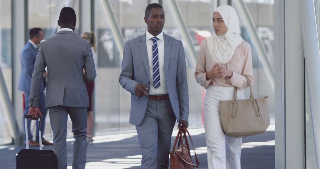 Diverse Professionals Walking Through Modern Office Hallway Discussing Business