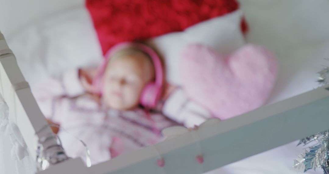 Blurry Baby Sleeping with Pink Headphones in Crib - Free Images, Stock Photos and Pictures on Pikwizard.com