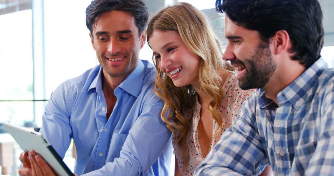 Happy Friends Using Tablet in Restaurant Setting