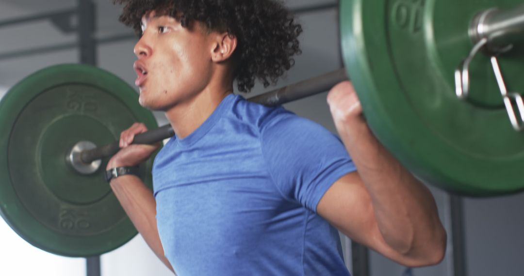 Determined Man Performing Weightlifting in Gym for Strength Building