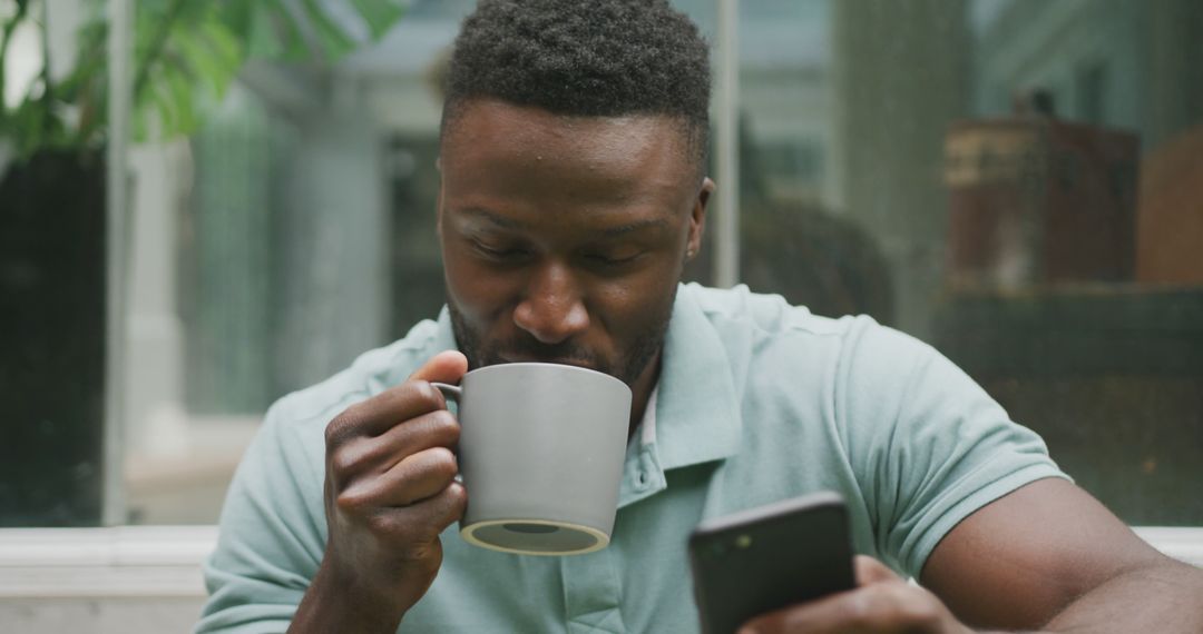 Relaxed man drinking coffee while using smartphone outdoors - Free Images, Stock Photos and Pictures on Pikwizard.com