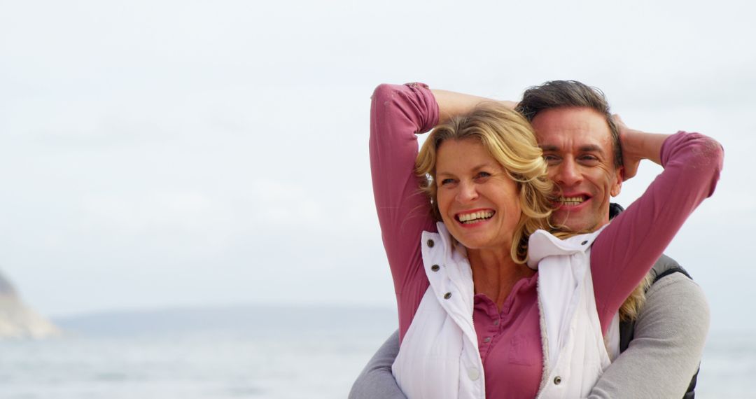 Happy Middle-aged Couple Embracing By Sea - Free Images, Stock Photos and Pictures on Pikwizard.com