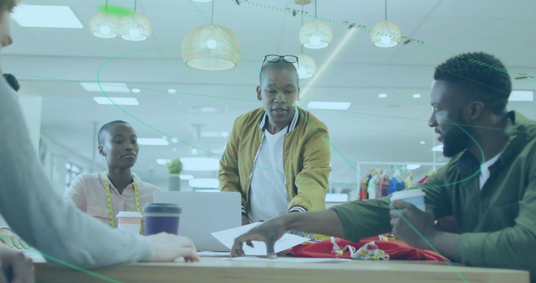 Diverse Fashion Designers Discuss Creative Ideas in Modern Workspace