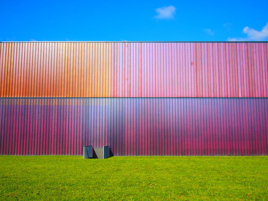 Colorful Metal Building Exterior With Bright Green Lawn On Sunny Day - Free Images, Stock Photos and Pictures on Pikwizard.com